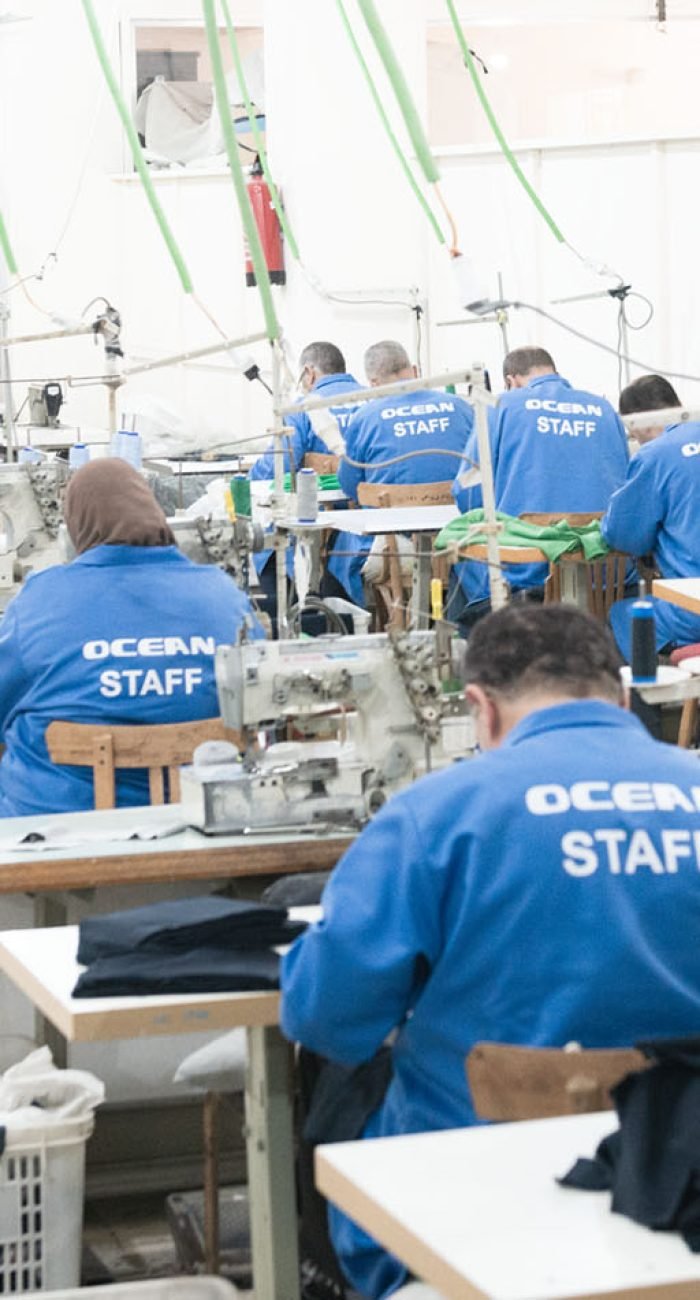 Ocean apparel manufacturing factory. Wrokers sewing on sewing machines